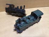 two toy trains sitting on a table next to each other