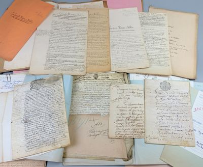 several old papers are piled on top of each other