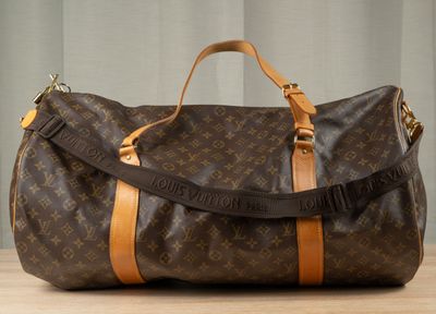 a brown and tan duffel bag sitting on a table