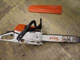an image of a chainsaw sitting on the ground