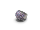 a close up of a ring with pink and blue stones