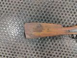 a wooden paddle on a metal surface with holes