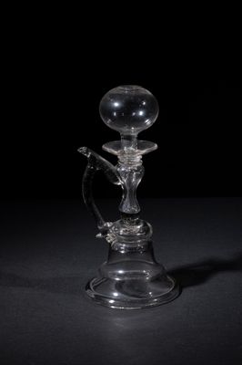 an old fashioned glass hooket with a glass handle on a black background