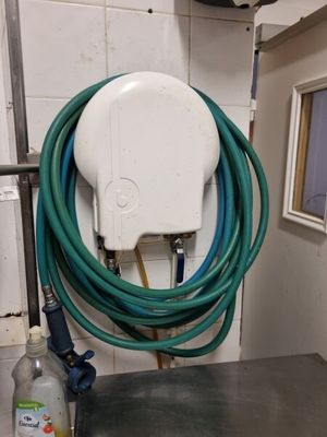 a hose and a spray bottle on a table in a room