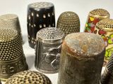 many different types of thimbles sitting on a table