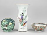 three vases and a bowl are sitting on a gray surface