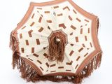 beige and brown umbrella with fringes on a white background