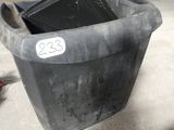 a black trash can with a number on it in a garage