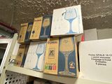 many boxes of wine glasses on a shelf in a room