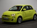 a yellow smart car parked in a room with a checkered floor