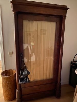 a mirror in the corner of a room with a bag on the floor