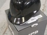 a helmet sitting on top of a box on the sidewalk