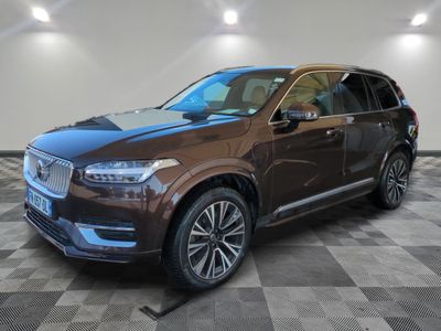 a brown volvo suv parked in a showroom with a checkered floor