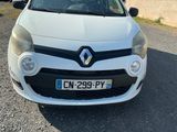 the front view of a white car parked in a parking lot