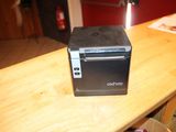 a small printer sitting on top of a wooden table