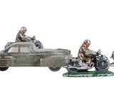 four figurines of people riding motorcycles and a car