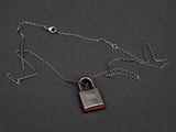necklace with a padlock on a chain on a black background