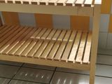 a wooden bench in a tiled room with yellow and white tiles