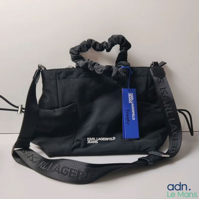 a black purse with a blue tag on it