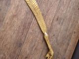 brass feather on a wooden table