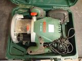 a green box with a drill and other tools in it