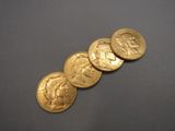 a close up of a row of gold coins on a gray surface