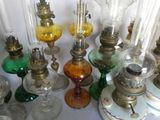 many different colored glass lamps sitting on a table