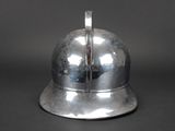 a silver helmet that is sitting on a table