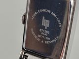 a silver watch with a black face on a silver bracelet