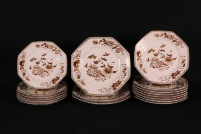 four plates are stacked on top of each other on a black surface