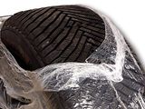 a close up of a motorcycle that is wrapped in plastic