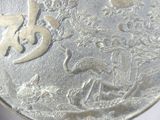 a close up of a silver coin with a bird on it