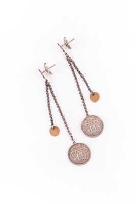 a pair of earrings with two coins hanging from them