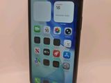a close up of a cell phone sitting on top of a table