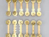 six pairs of gold plated brass spoons and a pair of brass spoons