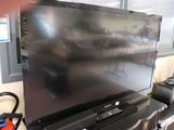 a large flat screen tv sitting on top of a table