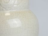 a white vase that has a cracky design on it