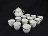 an image of a group of cups and a teapot on a black background