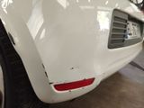 a close up of a white car with a number plate on it