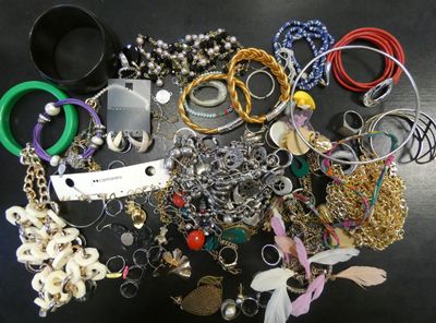 many different types of bracelets and rings on the table