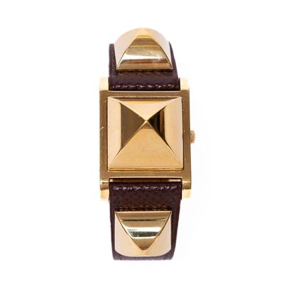 an image of a gold and brown watch on a white background