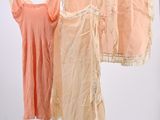 three shirts hanging on a clothes rack in a room