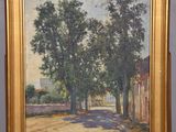 an oil painting of a country road with trees on a easel