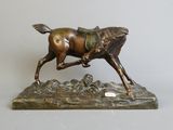 bronze statue of a horse with a rider on it ' s back