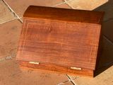 a small wooden box sitting on a tile floor