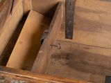 a wooden chest with a metal latch on it