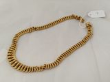 a gold chain necklace with a clasp on a white background