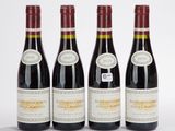 three bottles of wine are lined up on a white surface