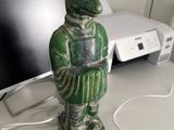 a statue of a bear on a desk with a calculator
