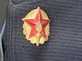 a red star on the lapel of a blue jacket